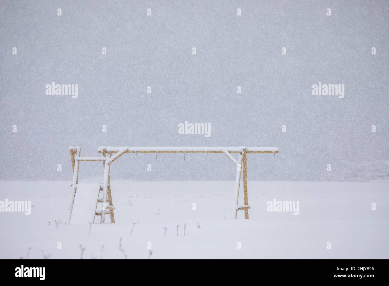 Altalene abbandonate nel parco giochi sulla neve Foto Stock