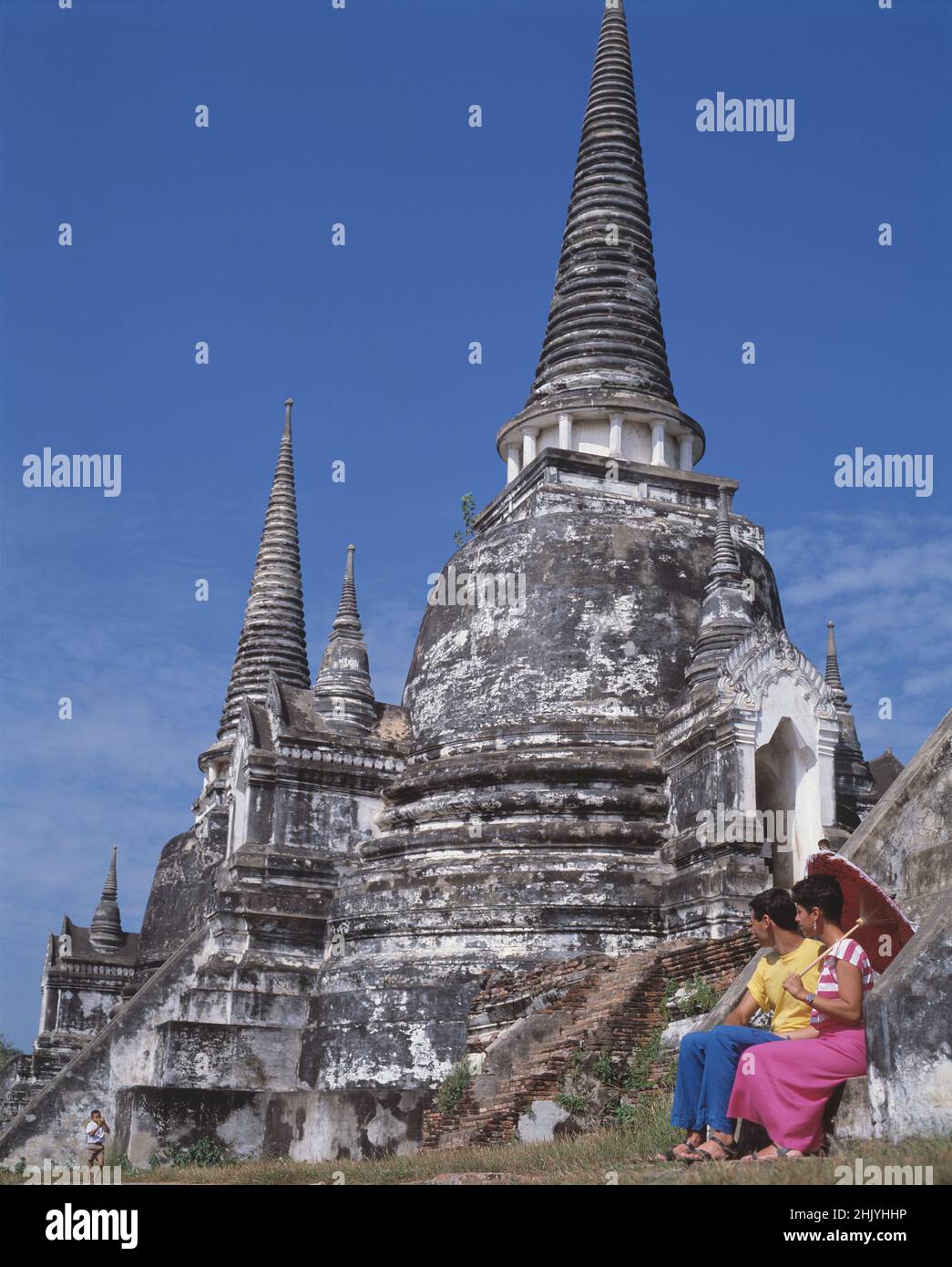 Thailandia. Phra Nakhon si Ayutthaya. Coppia turistica seduta da Wat Phra si Sanphet. Foto Stock