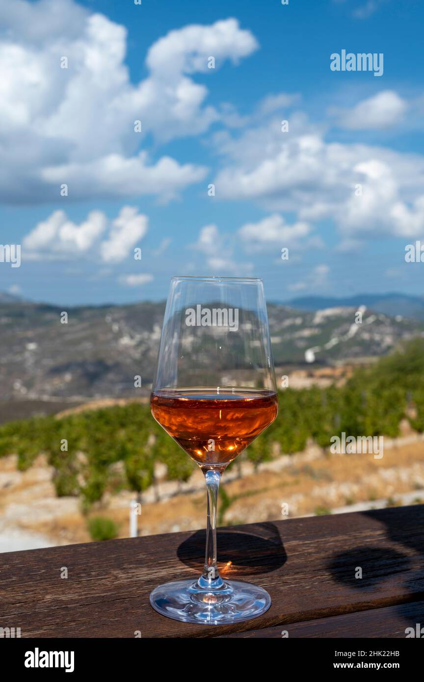 Industria del vino dell'isola di Cipro, degustazione di vino secco di rose in cantina con vista sui vigneti e le pendici meridionali della catena montuosa di Troodos in giornata di sole Foto Stock
