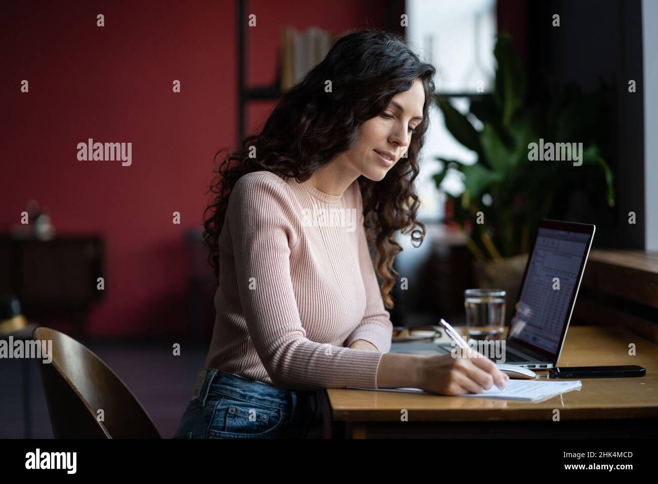 Giovane donna d'affari si prepara per la presentazione di rapporto finanziario e le vendite risultato prendere nota in notebook Foto Stock