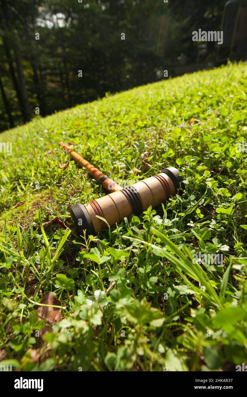 Croquet Mallet che si posa in erba Foto Stock