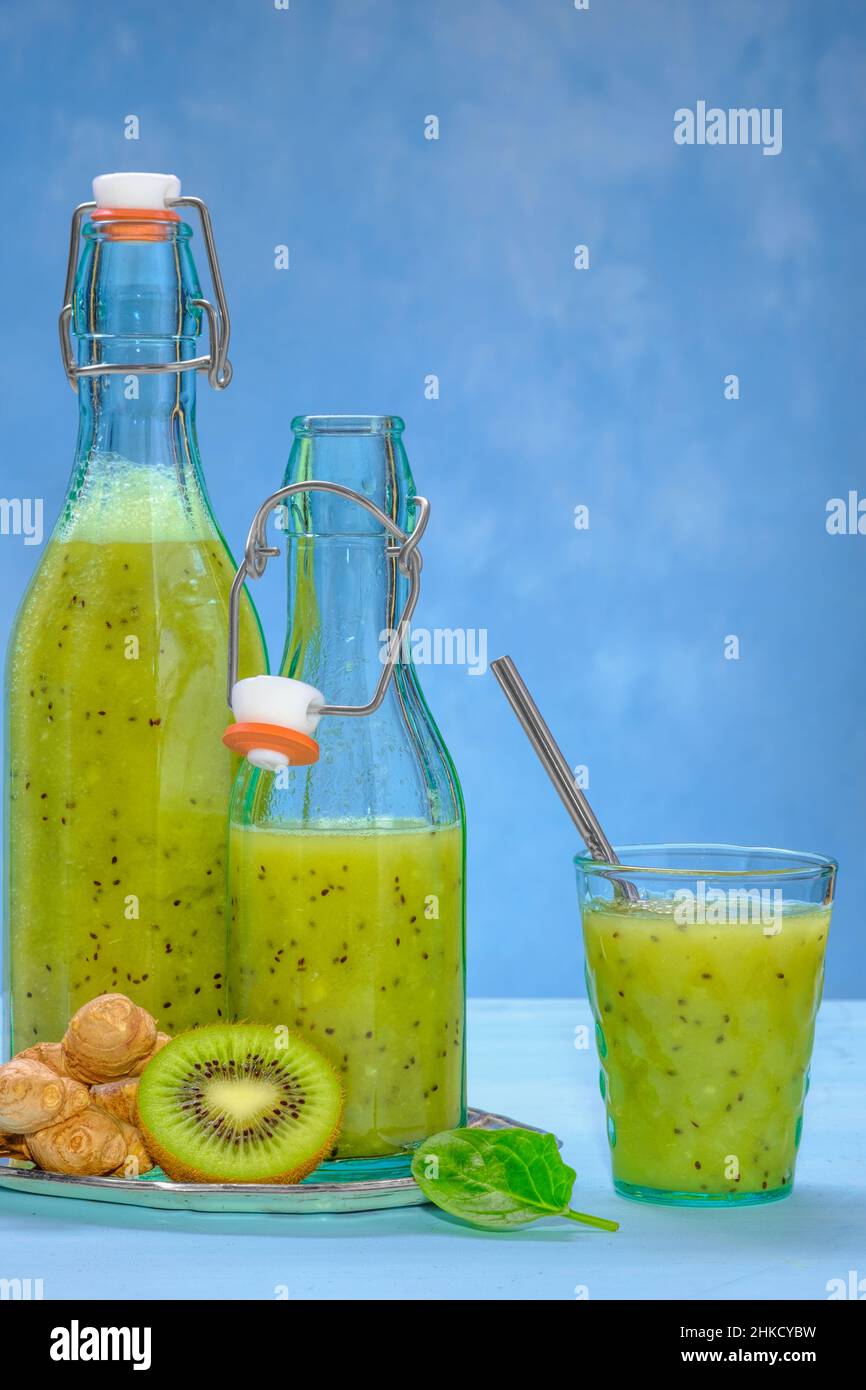 Bicchiere di spinaci verdi, arancia, zenzero e kiwi sani frullati Foto Stock