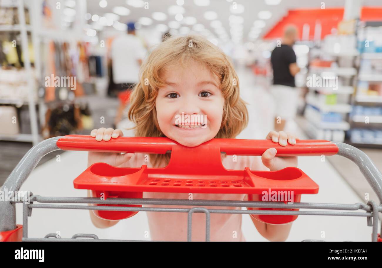 Bambino con cestino acquisto cibo in un negozio di alimentari. Clienti capretto che acquista i prodotti al supermercato. Foto Stock