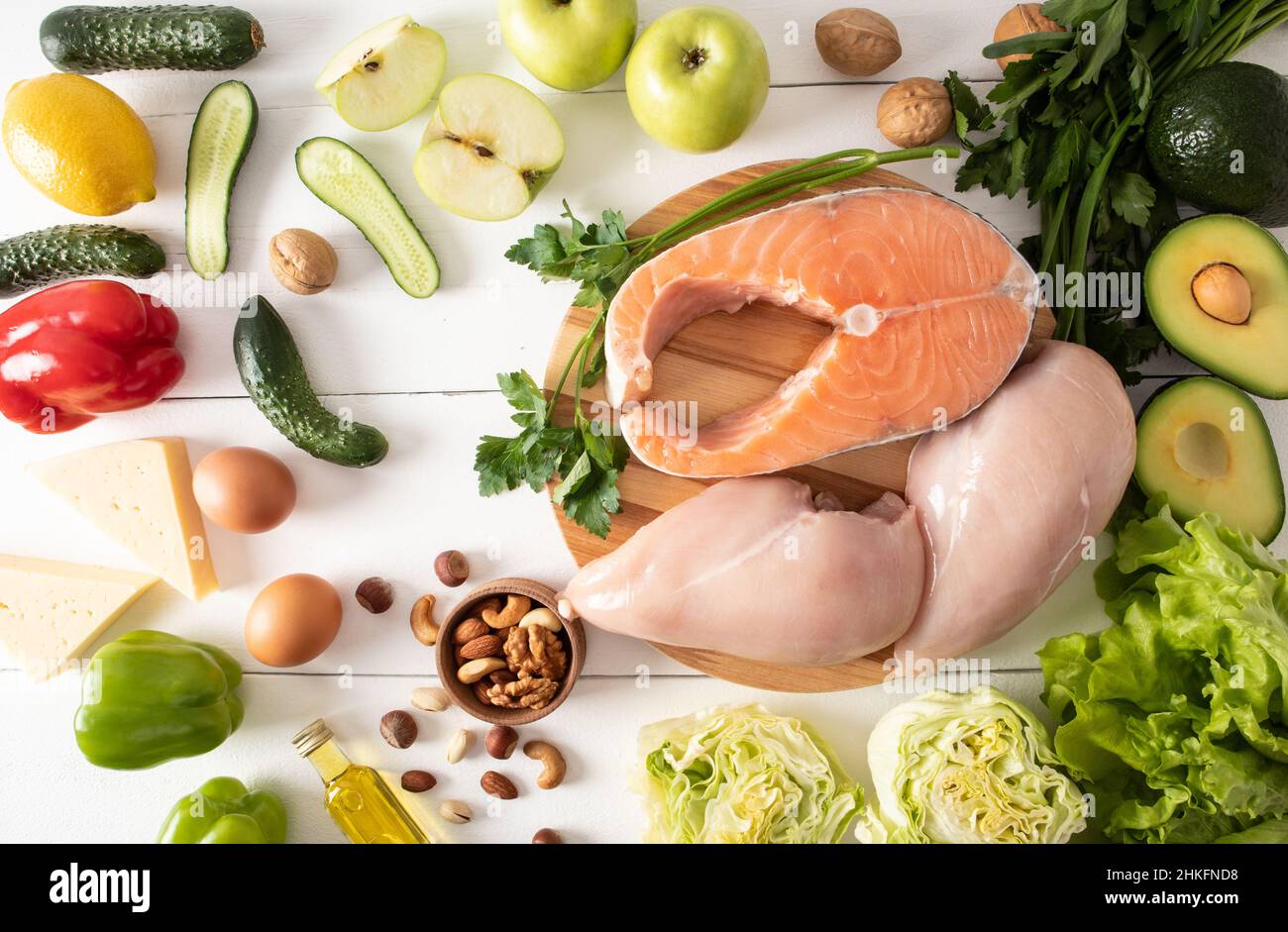Cibo sano con un alto contenuto di vitamina e e fibre dietetiche. Sfondo del cibo. Bistecca di salmone fresco, filetto di pollo, noci, uova. Vista dall'alto Foto Stock