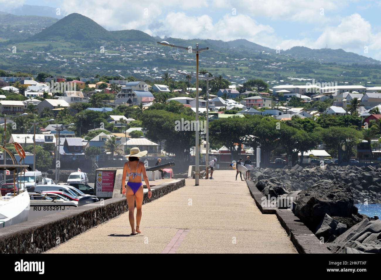 Francia, isola di Reunion (dipartimento francese d'oltremare), Saint Pierre, il porto turistico e il porto di pesca, escursionisti e surfisti sul molo Foto Stock