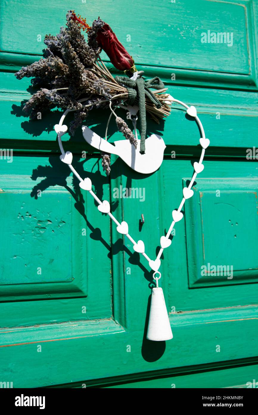 Fiori secchi e simbolo di pace appeso su una porta verde Teguise Lanzarote Isole Canarie Spagna Foto Stock