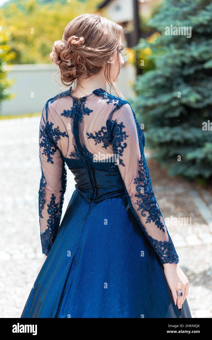 Vista posteriore di una ragazza in abito glamour ultramarino. Pronto per la sua notte di prom. Foto Stock
