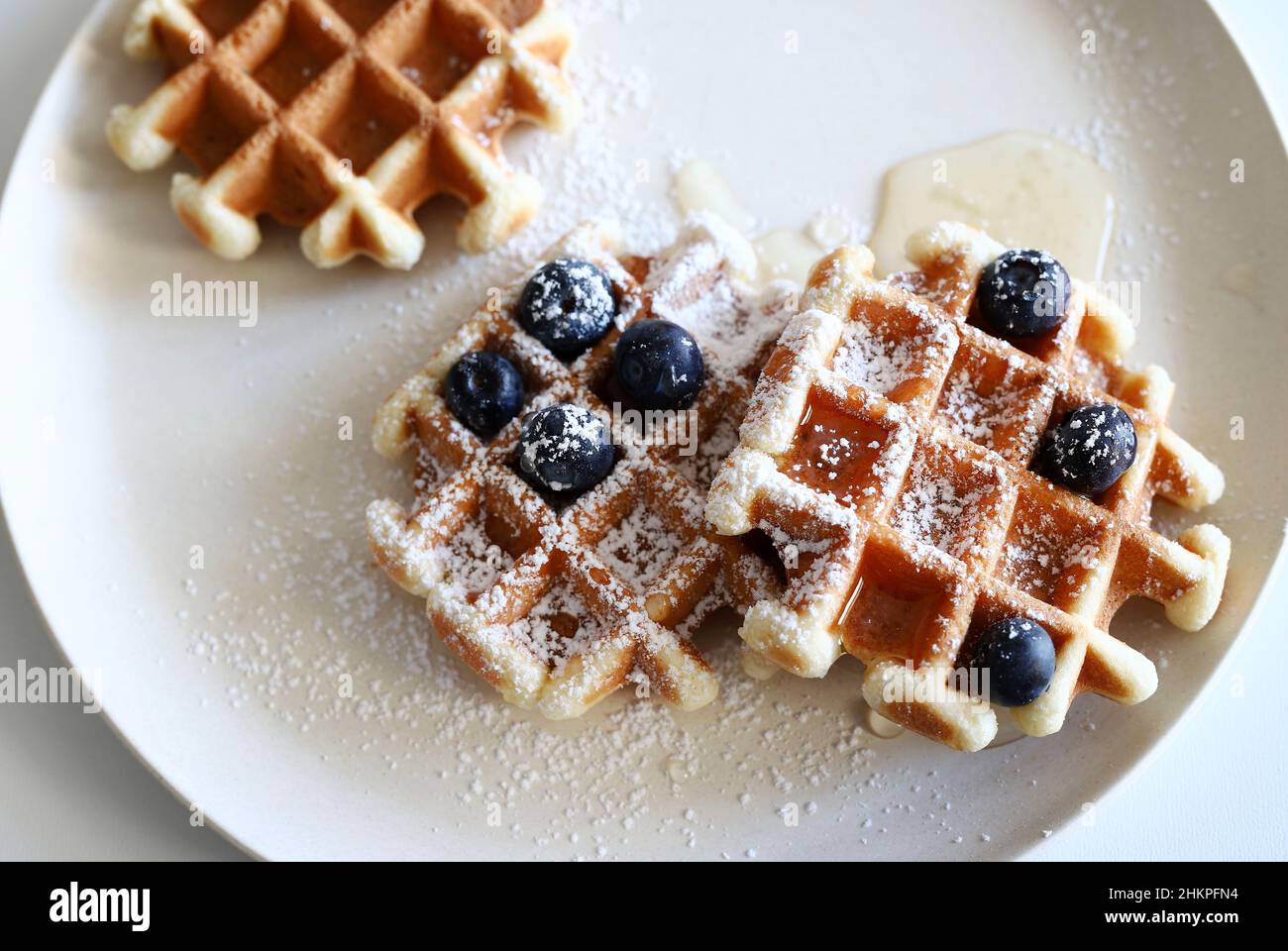 Cialde belghe con frutta fresca e miele su un piatto isolato su sfondo bianco. Direttamente sopra. Foto Stock