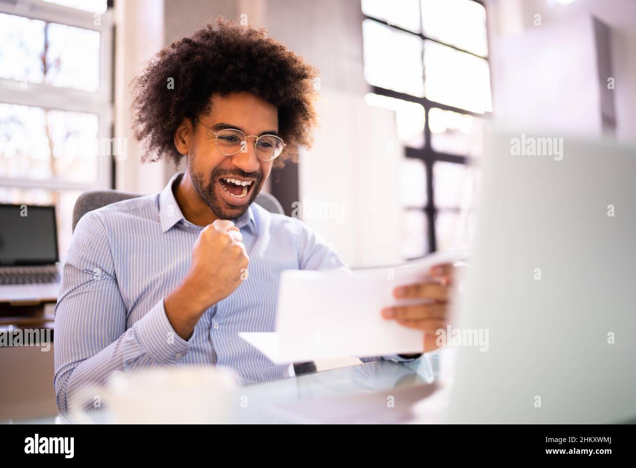 Happy Man leggendo una buona lettera di notizie con i risultati Foto Stock