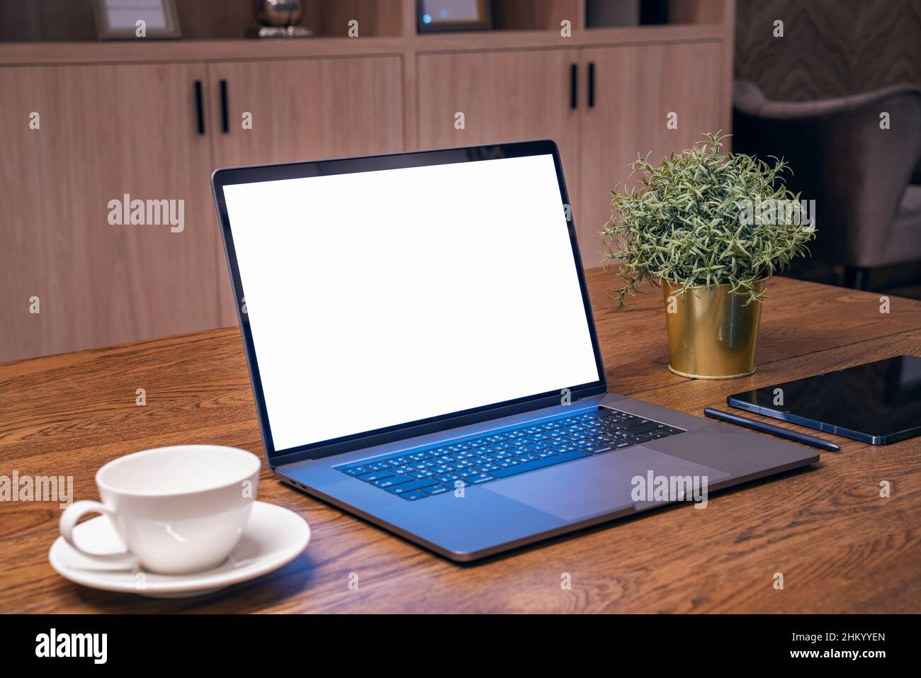 Computer portatile con schermo bianco sul tavolo. Lavoro da casa. Foto Stock