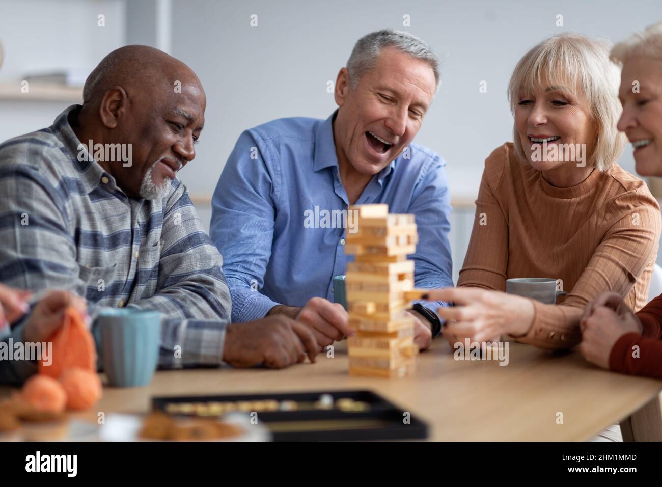 Gente anziana allegra che paga i giochi da tavolo insieme Foto Stock