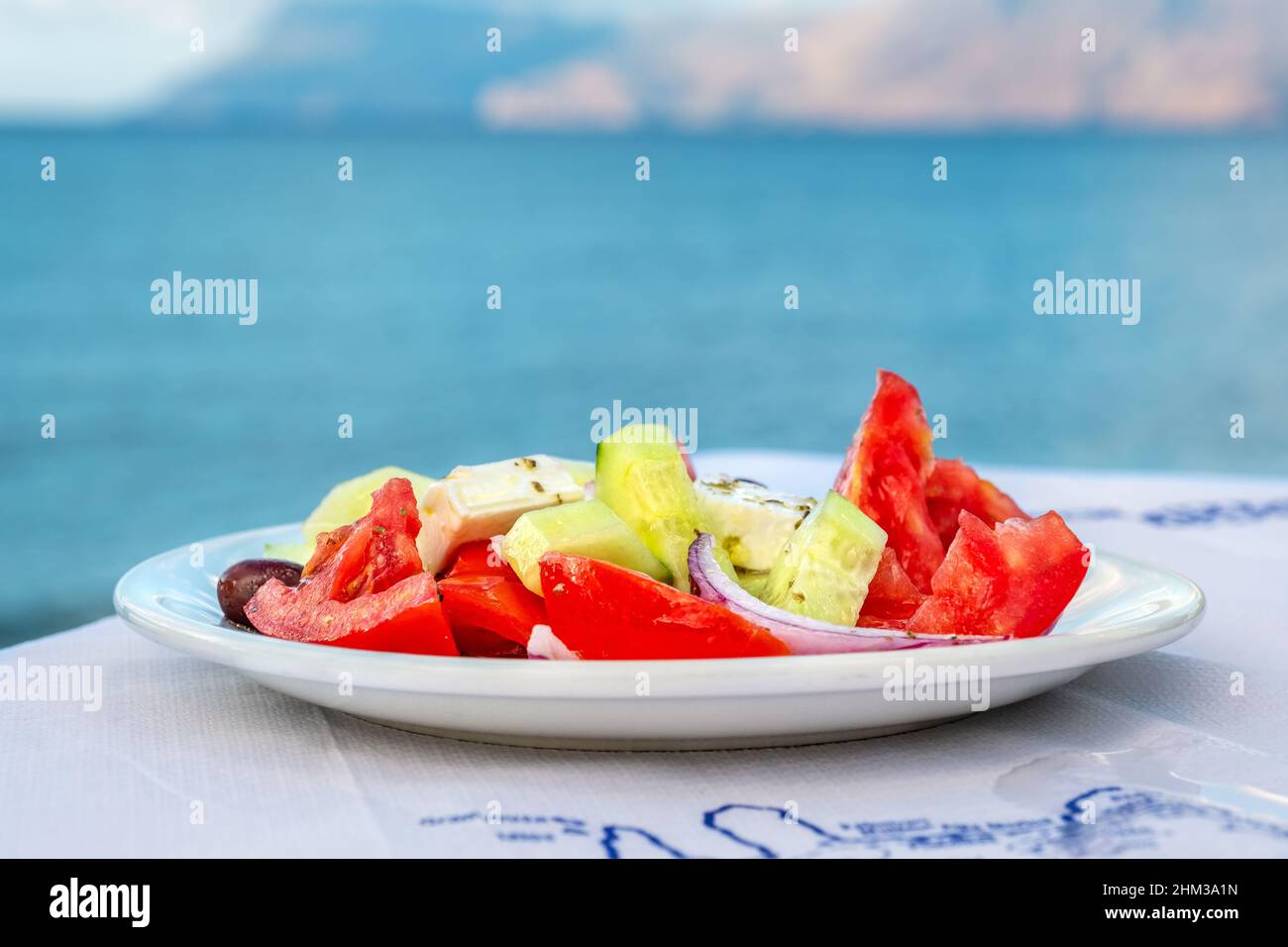 Insalata greca tradizionale su un tavolo in taverna sul mare. Creta, Grecia. Messa a fuoco selettiva Foto Stock