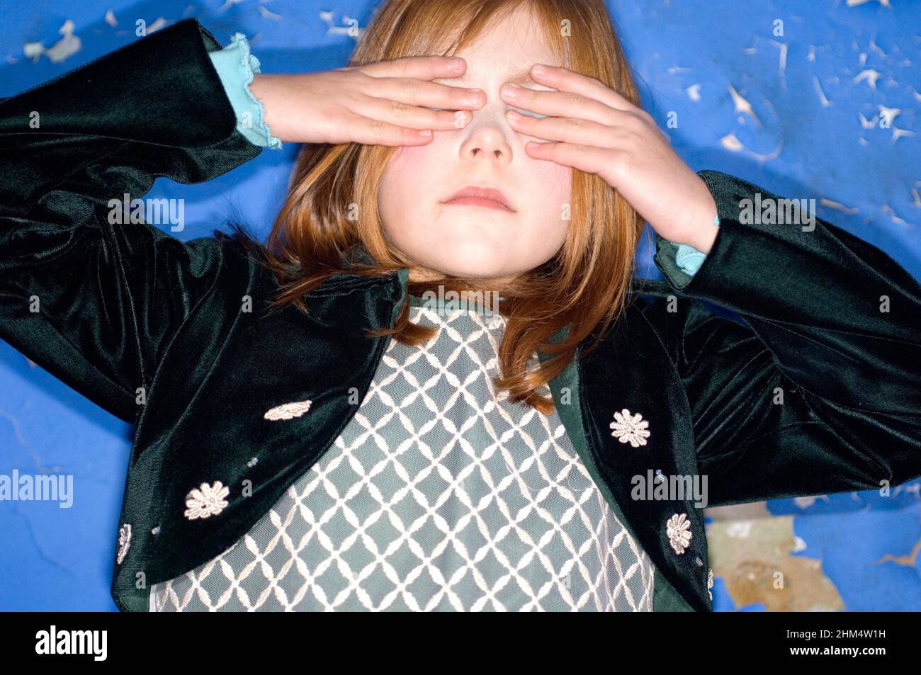 Little Girl Covering Eyes, Head Shot., Credit:Photoshot Creative / Stuart Cox / Avalon Foto Stock
