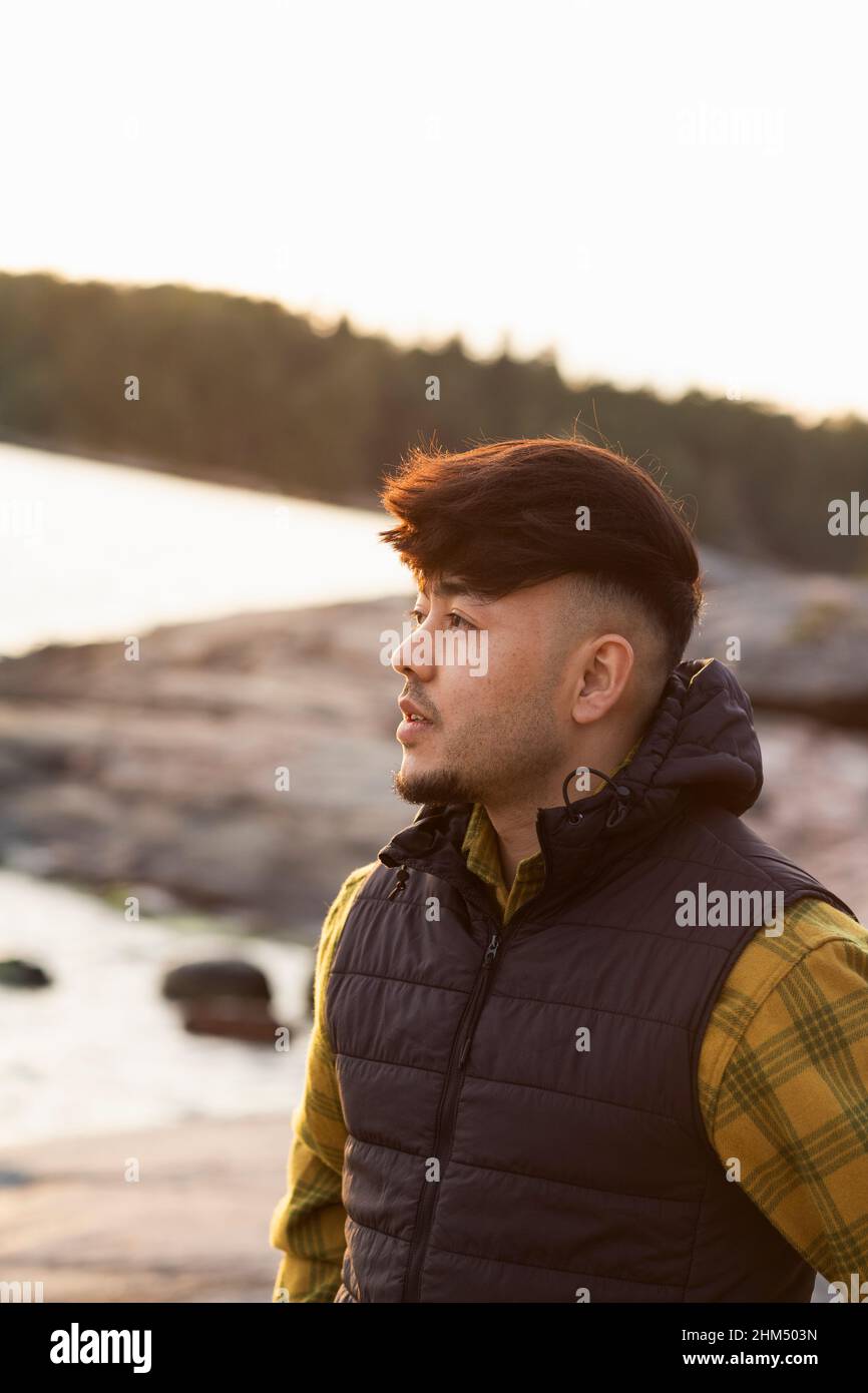 Giovane uomo che guarda lontano Foto Stock