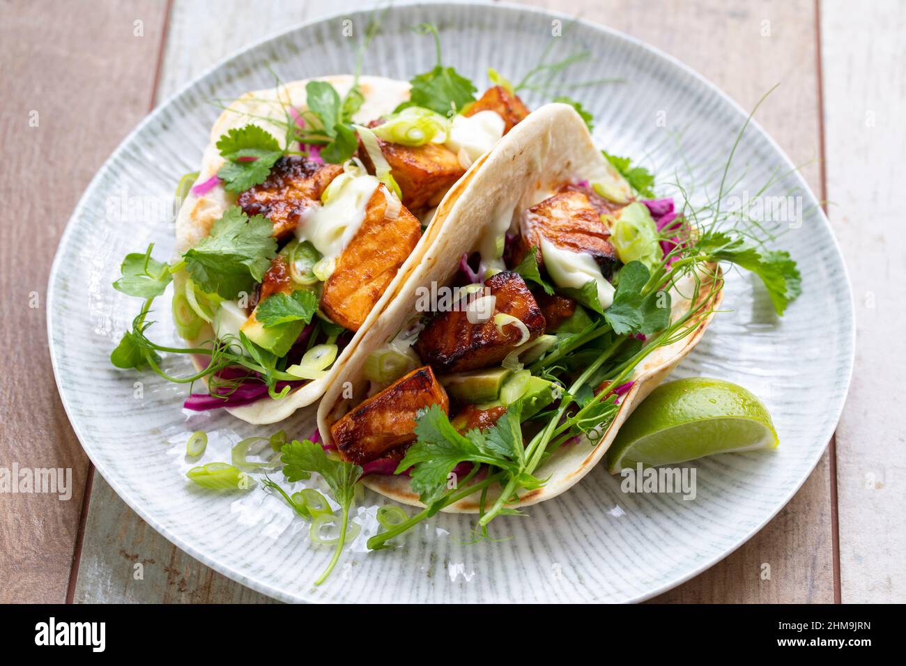 Tacos con salmone, cavolo rosso sottaceto, wasabi mayo e piselli spara Foto Stock