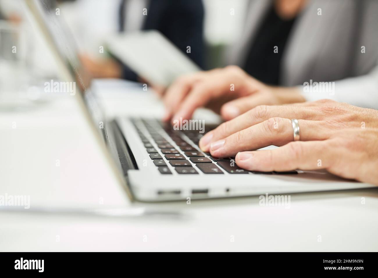 Le mani di un uomo d'affari che digita sulla tastiera del computer durante la programmazione o l'e-learning Foto Stock