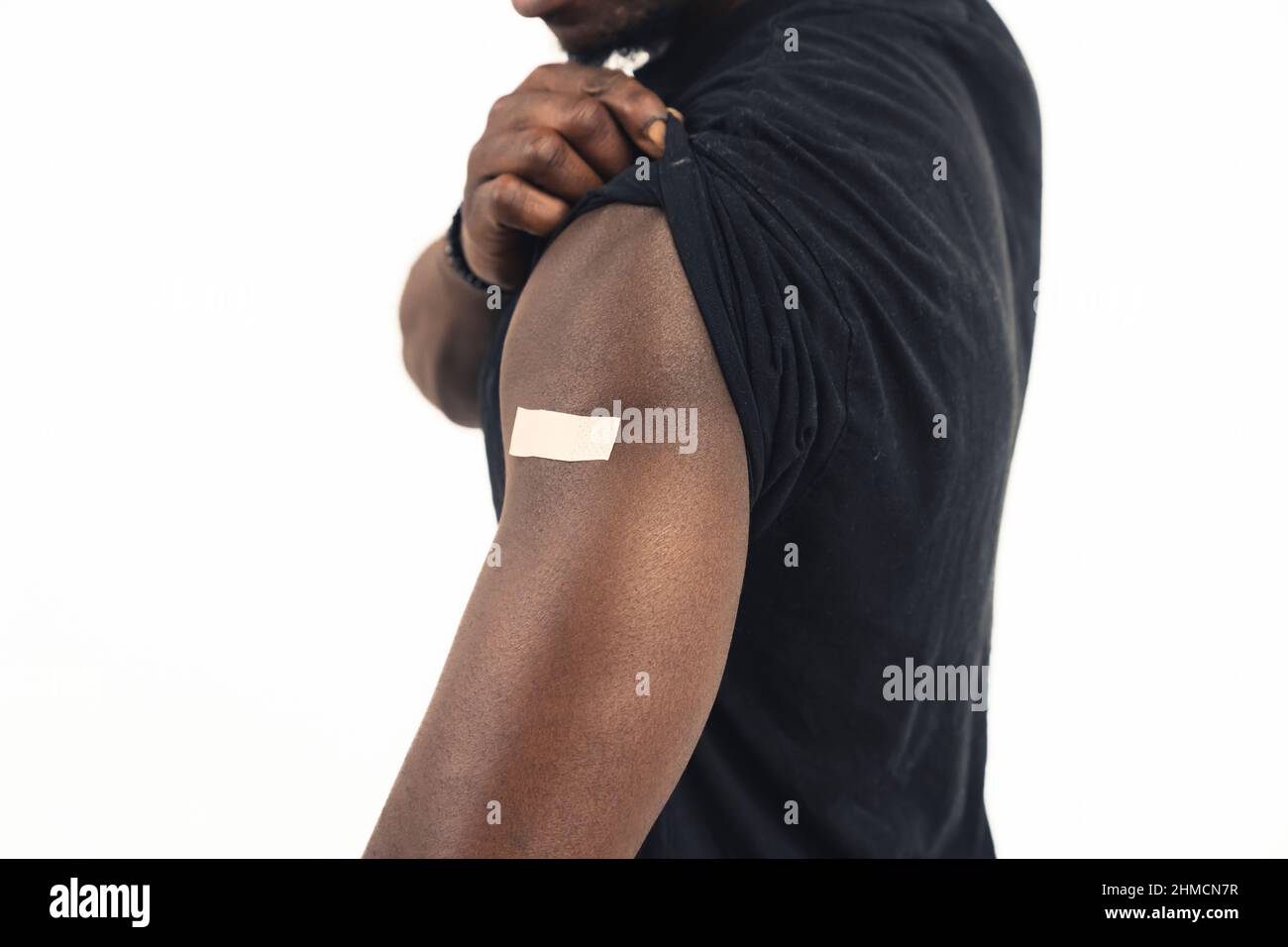 vaccinato nero uomo braccio sfondo bianco - primo piano scatto. Foto di alta qualità Foto Stock