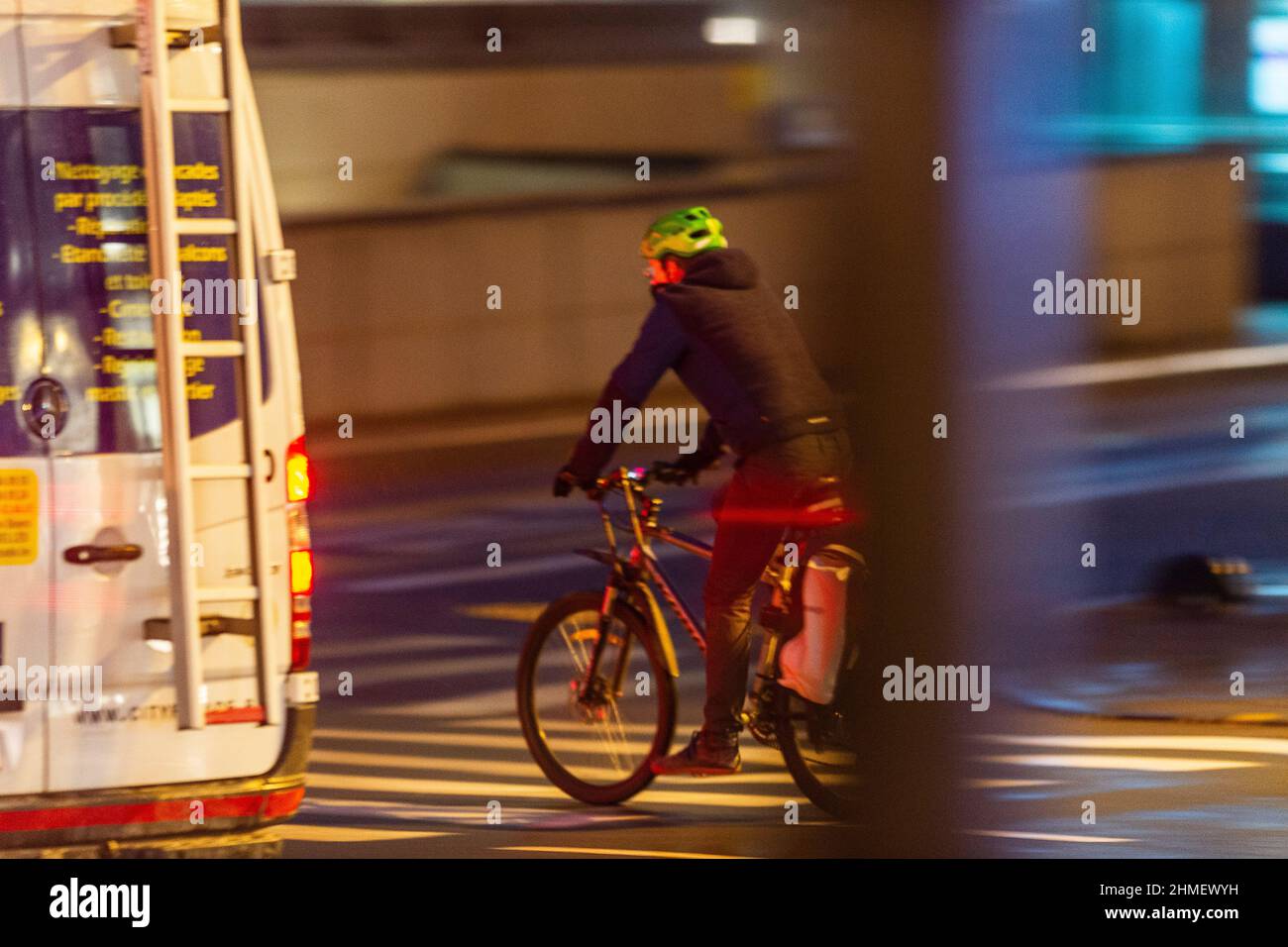 Cycliste sans gilet dans la Circulation routiere ciclista nel traffico senza la giacca di sicurezza Foto Stock