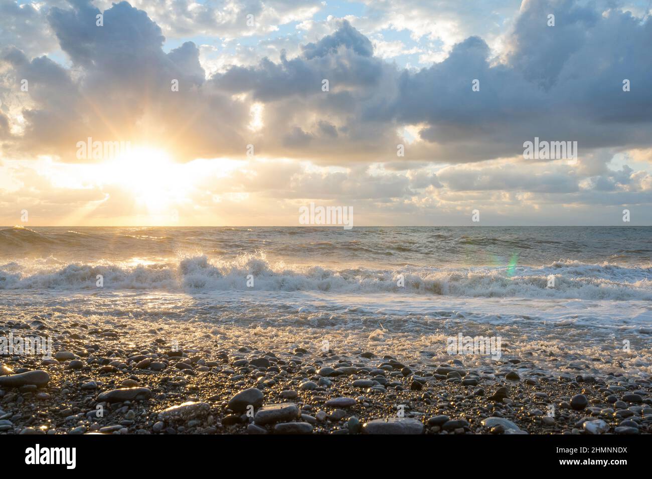 Un tramonto durante una tempesta. Una bellissima spiaggia di mare. Foto Stock