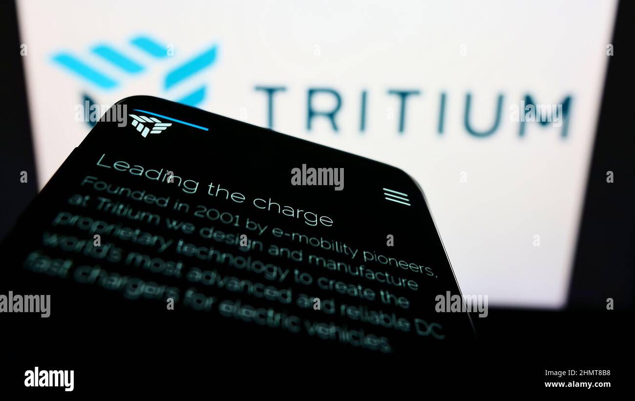 Telefono cellulare con pagina web della compagnia di ricarica EV Tretium Holdings Pty Ltd sullo schermo di fronte al logo aziendale. Mettere a fuoco sulla parte superiore sinistra del display del telefono. Foto Stock