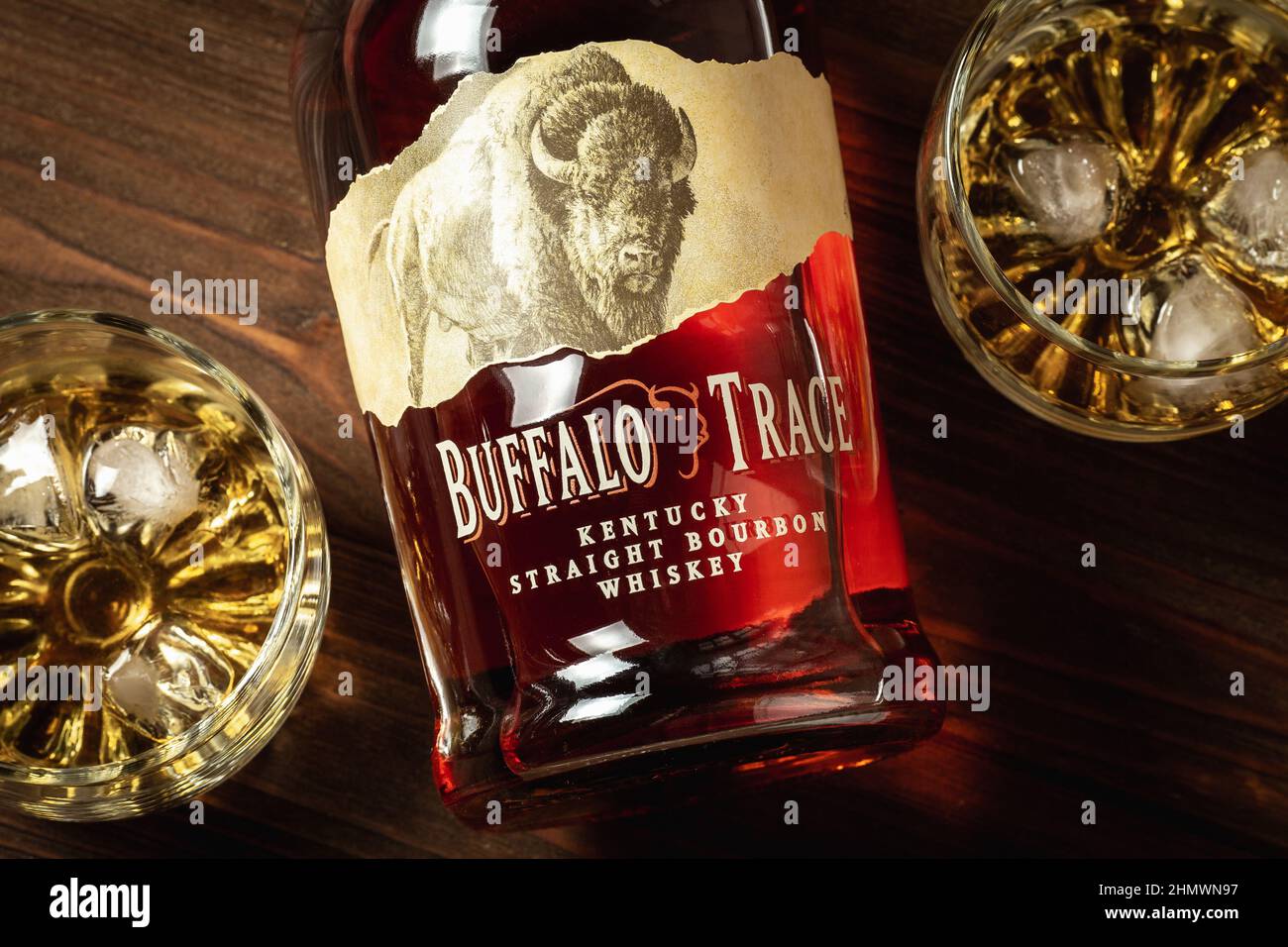 Ternopil, Ucraina - 29 aprile 2021: Una bottiglia di Buffalo Trace Kentucky Straight Bourbon whiskey e due bicchieri con ghiaccio e borbone su un tavolo di legno Foto Stock