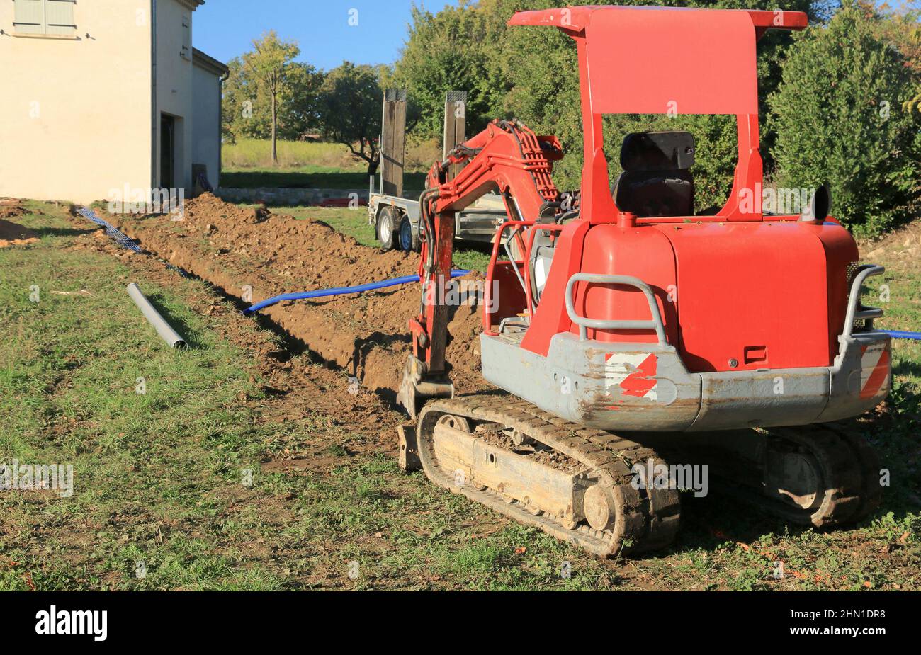 Posa di tubi nella trincea di collegamento di una casa. Foto Stock