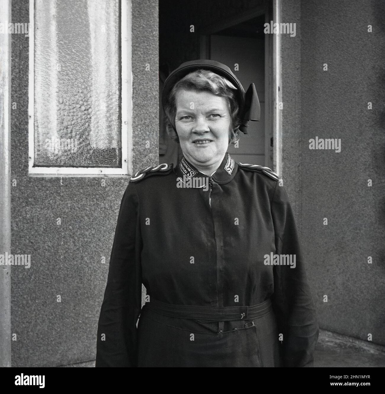 1960s, storica, in piedi per la sua foto fuori di una casa, una signora nella sua uniforme dell'esercito di salvezza dei Songsters di Dunfermline, Dunfermline, Scozia, Regno Unito. Foto Stock