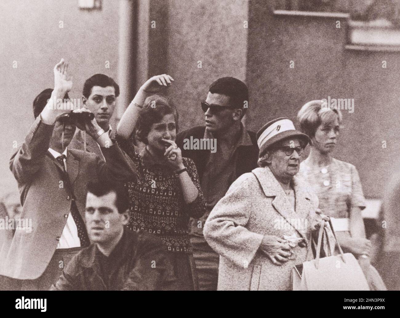 Foto d'epoca della crisi di Berlino del 1961: Costruire il Muro Tears a Berlino Ovest. Una giovane coppia a Berlino Ovest guarda attraverso la linea divisoria della famiglia Foto Stock