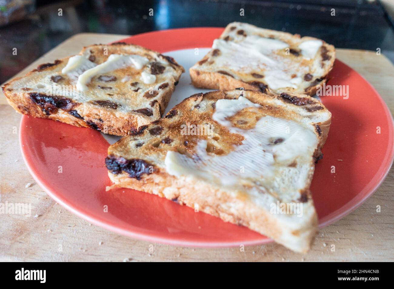 La focaccia alla frutta macinata e tostata su un piatto è un alimento confortevole da consumare a colazione o come gustoso spuntino. Foto Stock