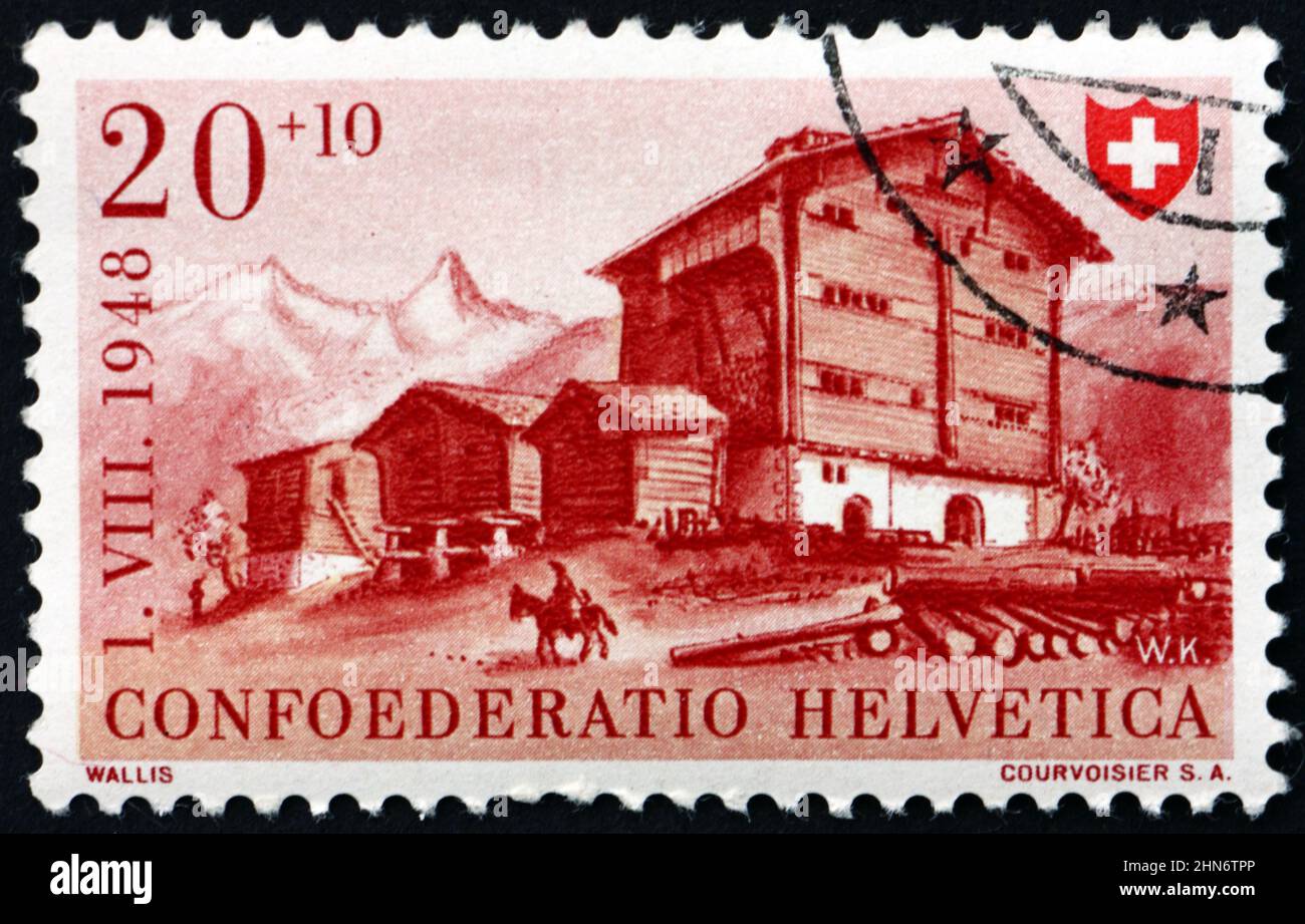 SVIZZERA - CIRCA 1948: Un francobollo stampato in Svizzera mostra Casa del Vallese, fete nazionale, circa 1948 Foto Stock