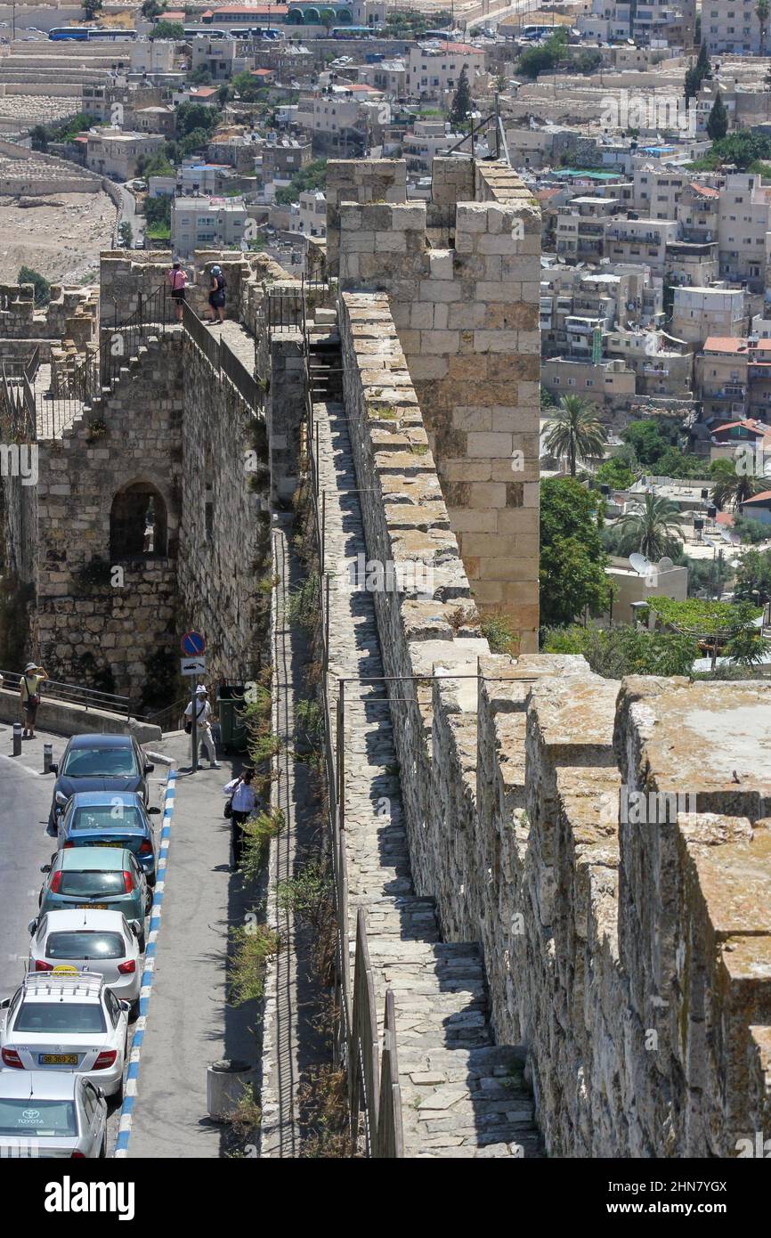 Le auto si parcheggiano lungo le antiche mura della storica città vecchia di Gerusalemme, Israele. Foto Stock