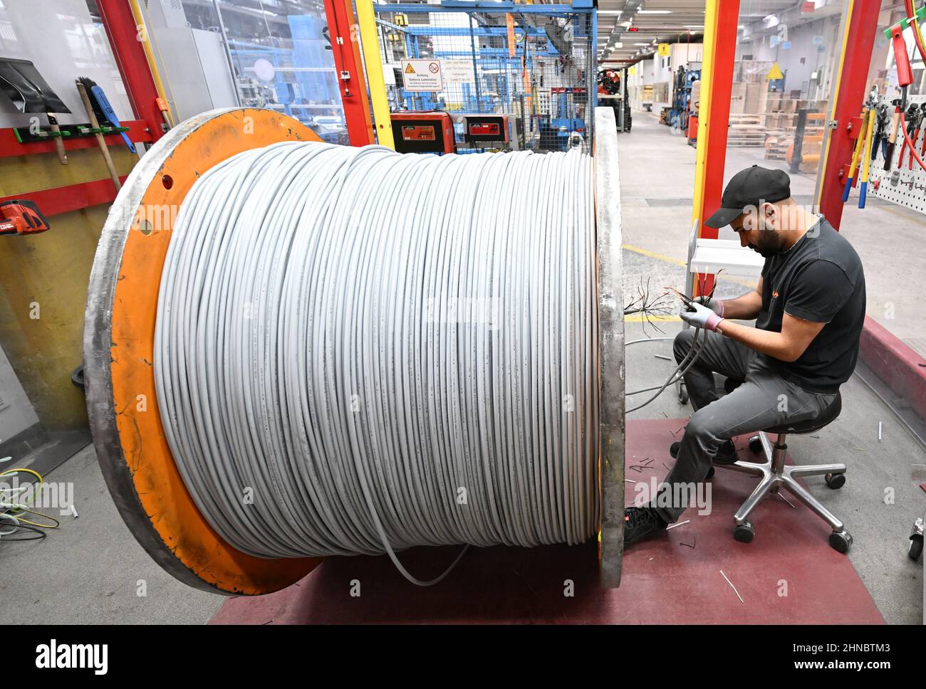 Stoccarda, Germania. 15th Feb 2022. Un lavoratore del produttore di cavi Lapp Kabel sta lavorando su un tamburo per cavi. Il produttore mondiale di cavi annuncerà i dati relativi all'ultimo anno fiscale nel corso di una conferenza stampa online il 16 febbraio. Credit: Bernd Weißbrod/dpa/Alamy Live News Foto Stock