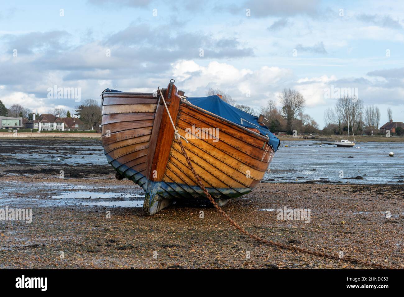 Barca di legno sulla sabbia a bassa marea in Bosham, Sussex occidentale, Inghilterra, Regno Unito Foto Stock