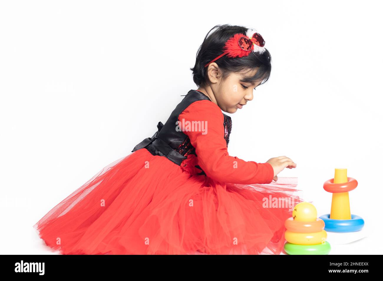 Asian Indian Girl giocando con blocchi di impilamento con forme ordinamento isolato su sfondo bianco. Divertimento, attività, Pre School, educativo, Kindergarten, Foto Stock