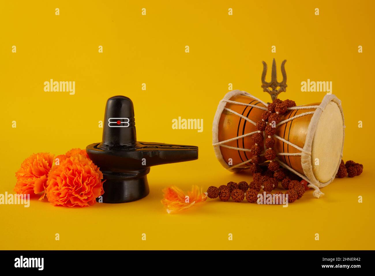 Happy Maha Shivaratri biglietto d'auguri - Shiva Linga decorato con fiori, triscola e damru. Festa indù celebrata del Signore Shiva Foto Stock