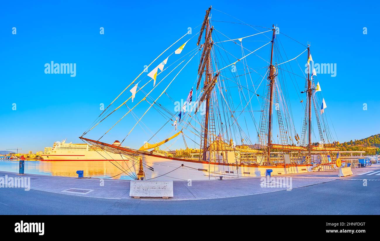 La panoramica nave a vela in legno ormeggiata nel porto di Malaga di fronte al moderno battello da crociera, Spagna Foto Stock