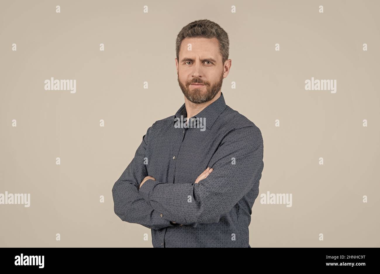 Potete sempre essere sicuri. Uomo sicuro tenere le braccia incrociate sfondo grigio. Stile casual Foto Stock