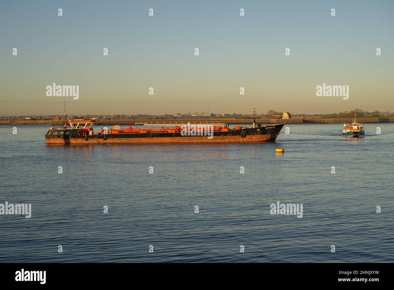 Distributore una nave cisterna carburante fuori dal molo di Gravesend città con Tilbury traghetto alle spalle Foto Stock