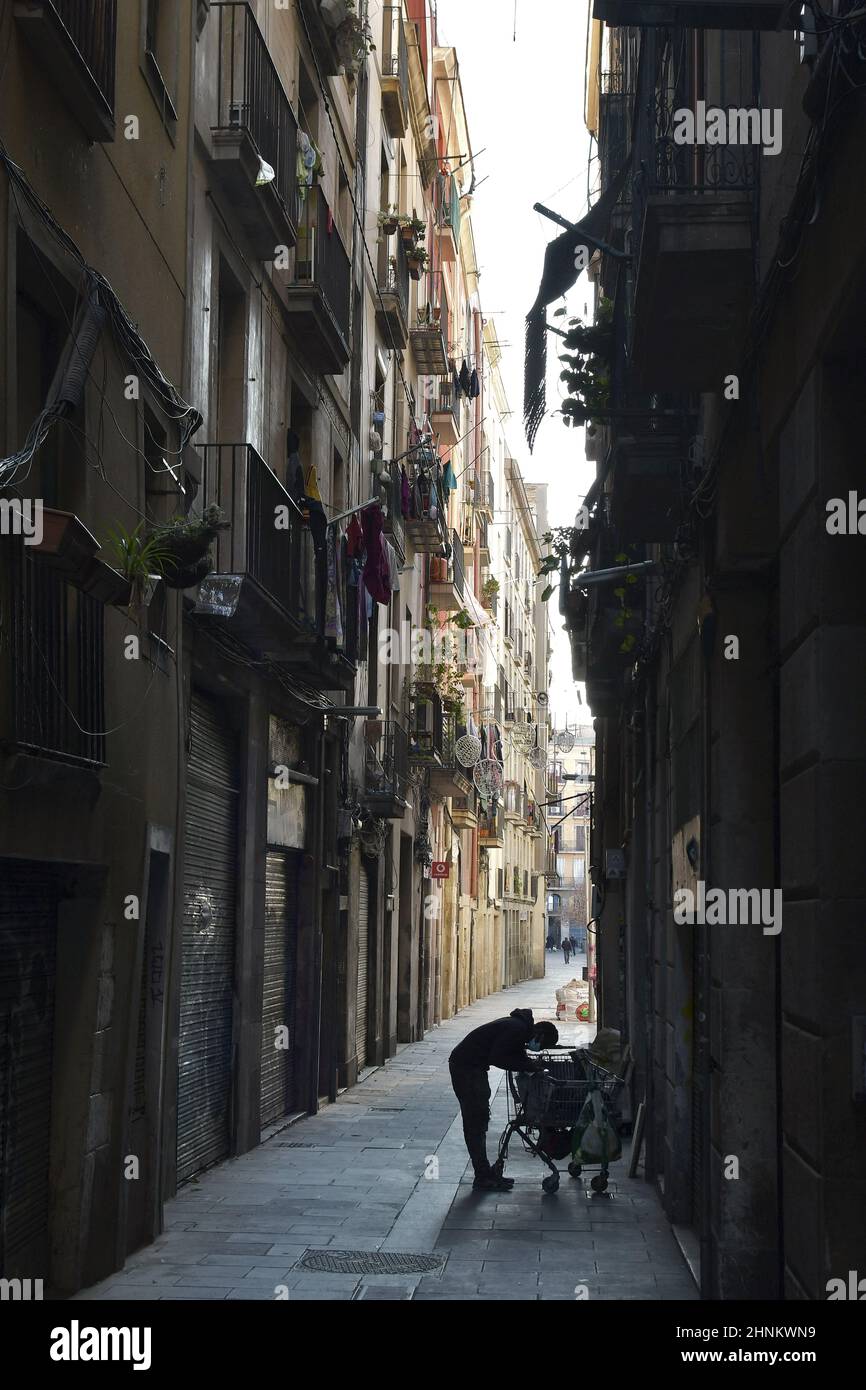 Collezionista di articoli di scarto con il suo carrello nella strada del quartiere El Raval , che ha una comunità di immigrati molto diversa, Barcellona Spagna. Foto Stock