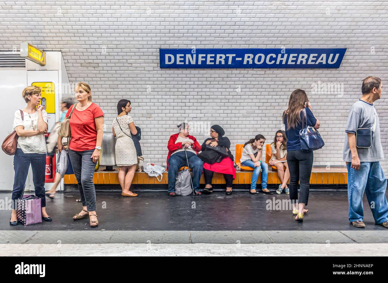 La gente aspetta nella stazione della metropolitana per il treno che arriva Foto Stock