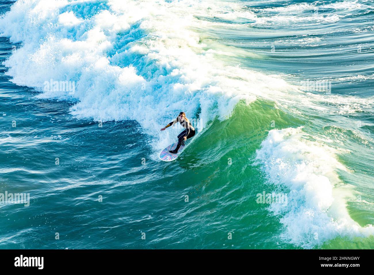 Surfer gode le onde a Manhattan Beach vicino Los Angeles. Foto Stock