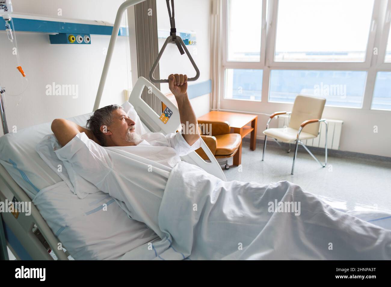 Paziente presso un ospedale, guardando da una finestra nella sua camera, facendo molto meglio dopo la chirurgia Foto Stock
