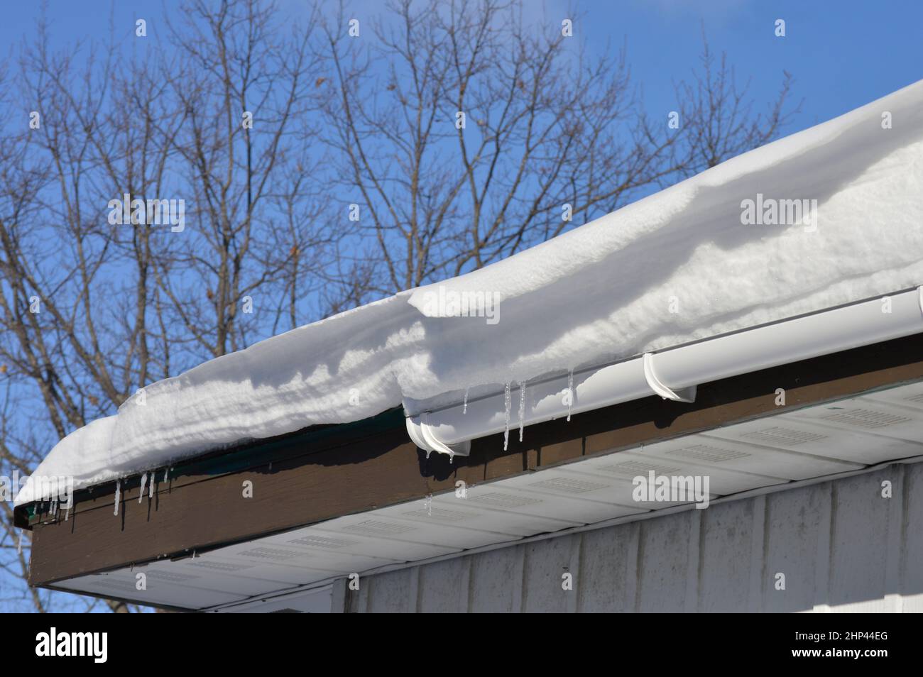 La neve scivole su un tetto dopo una grande nevicata Foto Stock