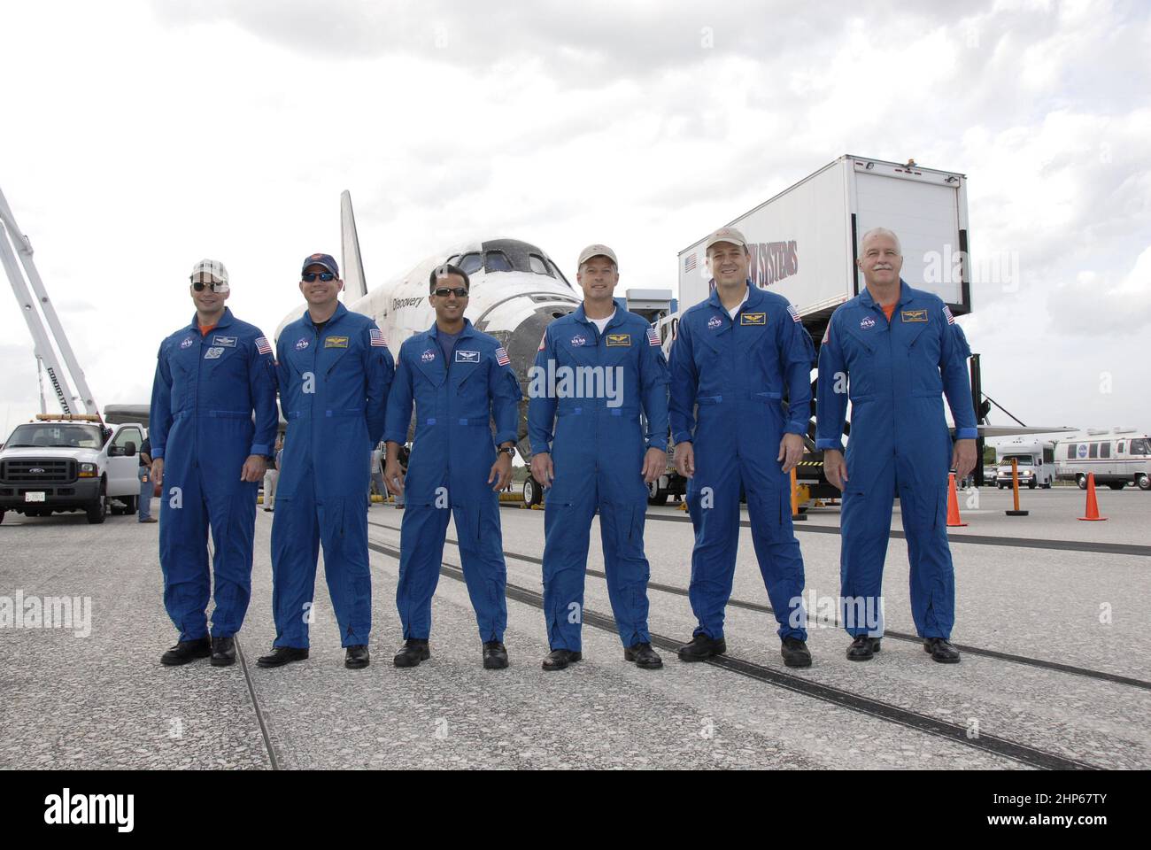 I membri dell'equipaggio della STS-119 posano per un ritratto di gruppo di fronte allo Space Shuttle Discovery sulla Runway 15 al Kennedy Space Center della NASA in Florida, dopo il ritorno dal loro viaggio di 13 giorni, 5,3 milioni di miglia sulla missione STS-119 alla Stazione spaziale Internazionale. Da sinistra ci sono il comandante Lee Archambault, il pilota Tony Antonelli e gli specialisti della missione Joseph Acaba, Steve Swanson, Richard Arnold e John Phillips ca. 2009 Foto Stock