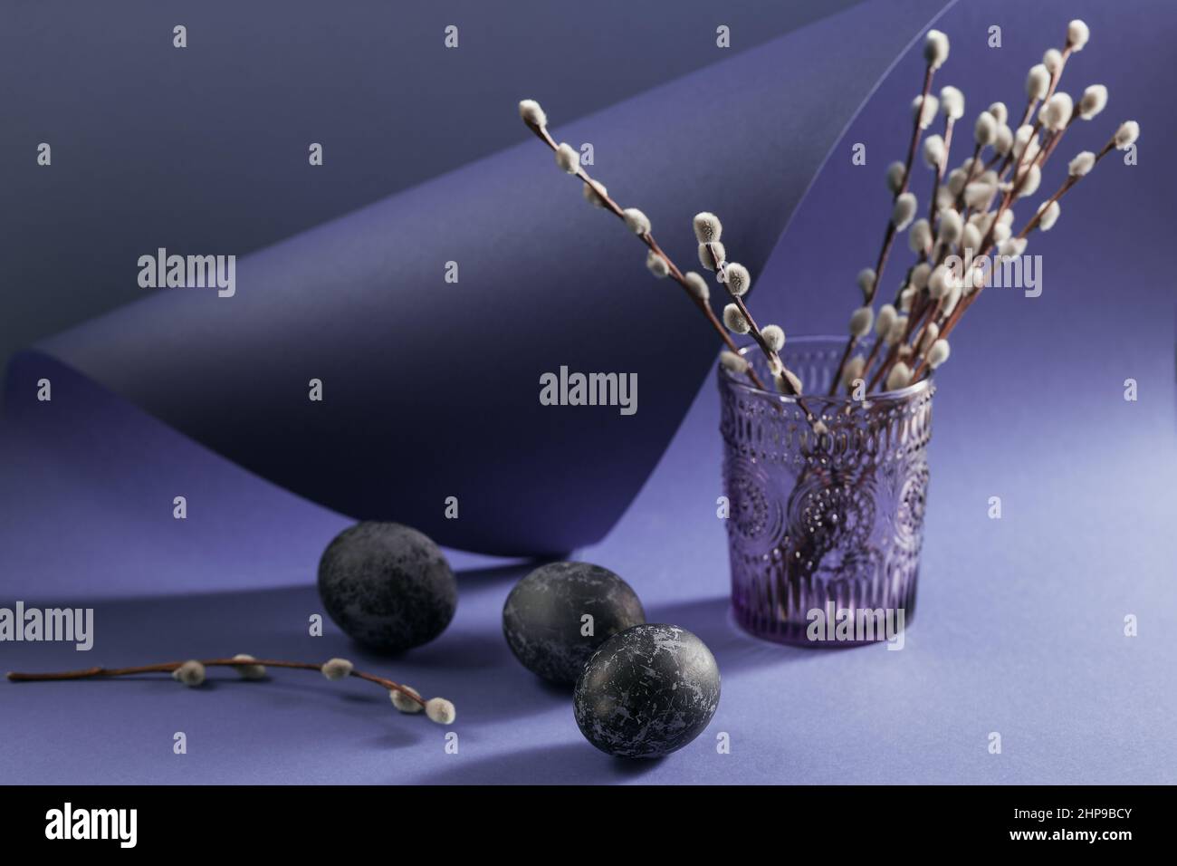 Felice cattolica e ortodossa vacanza di Pasqua sfondo creativo. Pollo pasquale e uova di quaglia dipinte a mano in marmo blu effetto colore su vio Foto Stock