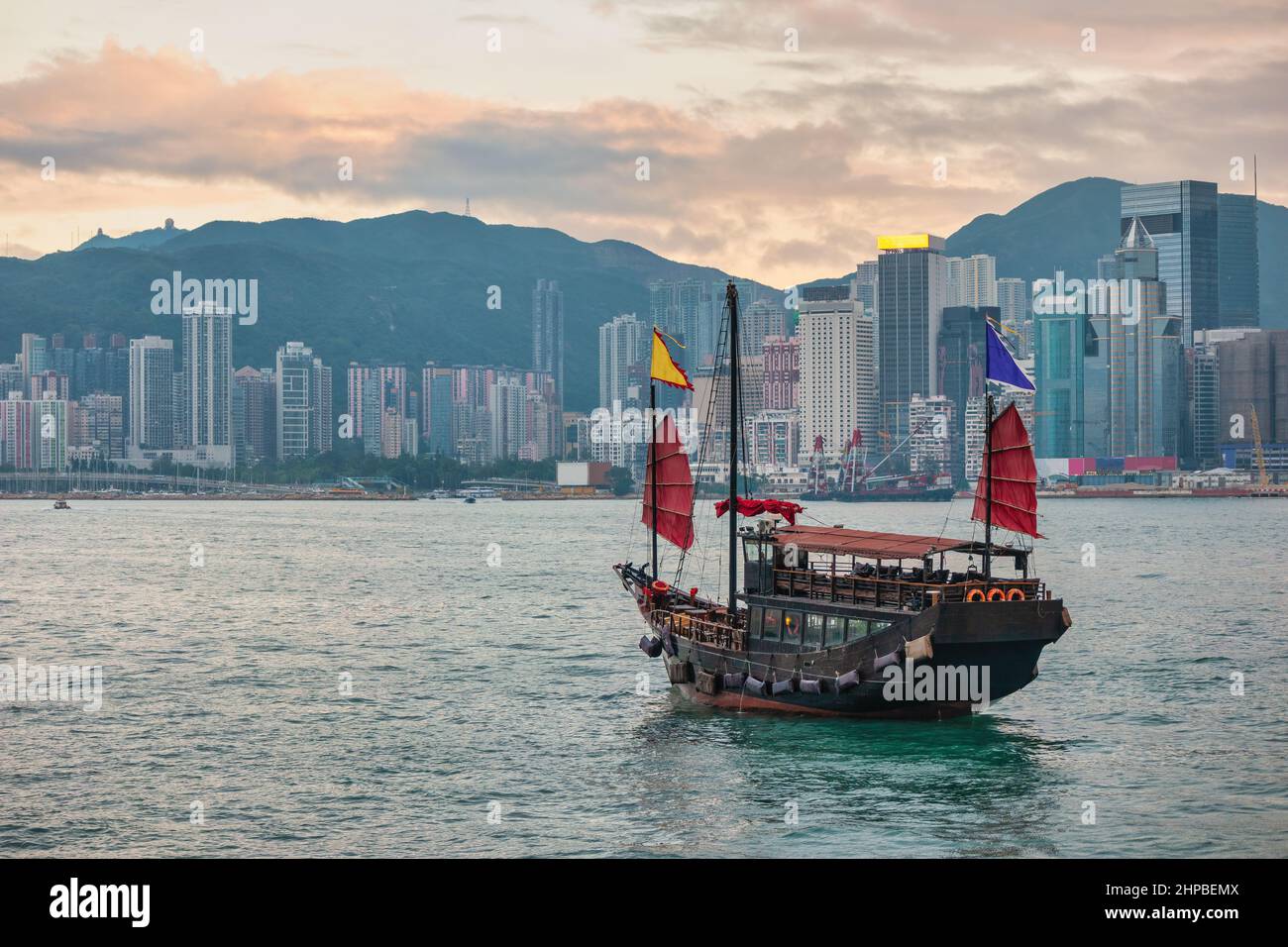 Skyline della città di Hong Kong a Victoria Bay con barca spazzatura e grattacielo quartiere degli affari Foto Stock