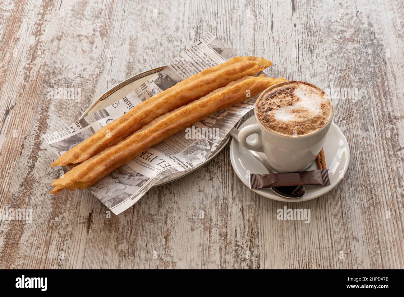 Prima colazione spagnola con caffè con latte e un paio di porras su tavola in legno sottaceto Foto Stock