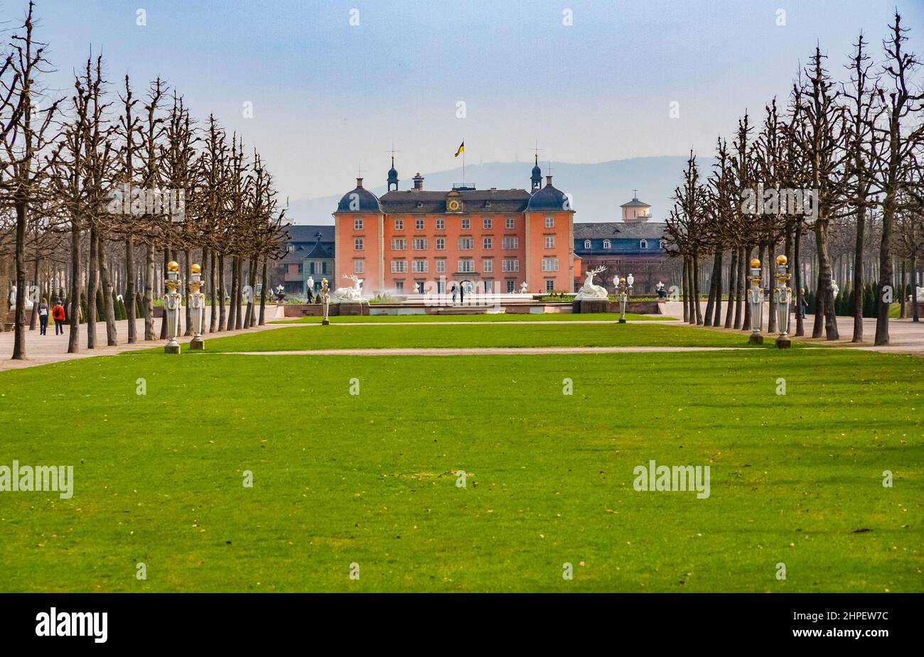 Bella vista panoramica del famoso Palazzo Schwetzingen visto dal famoso giardino barocco con il parterre circolare e la scultura... Foto Stock