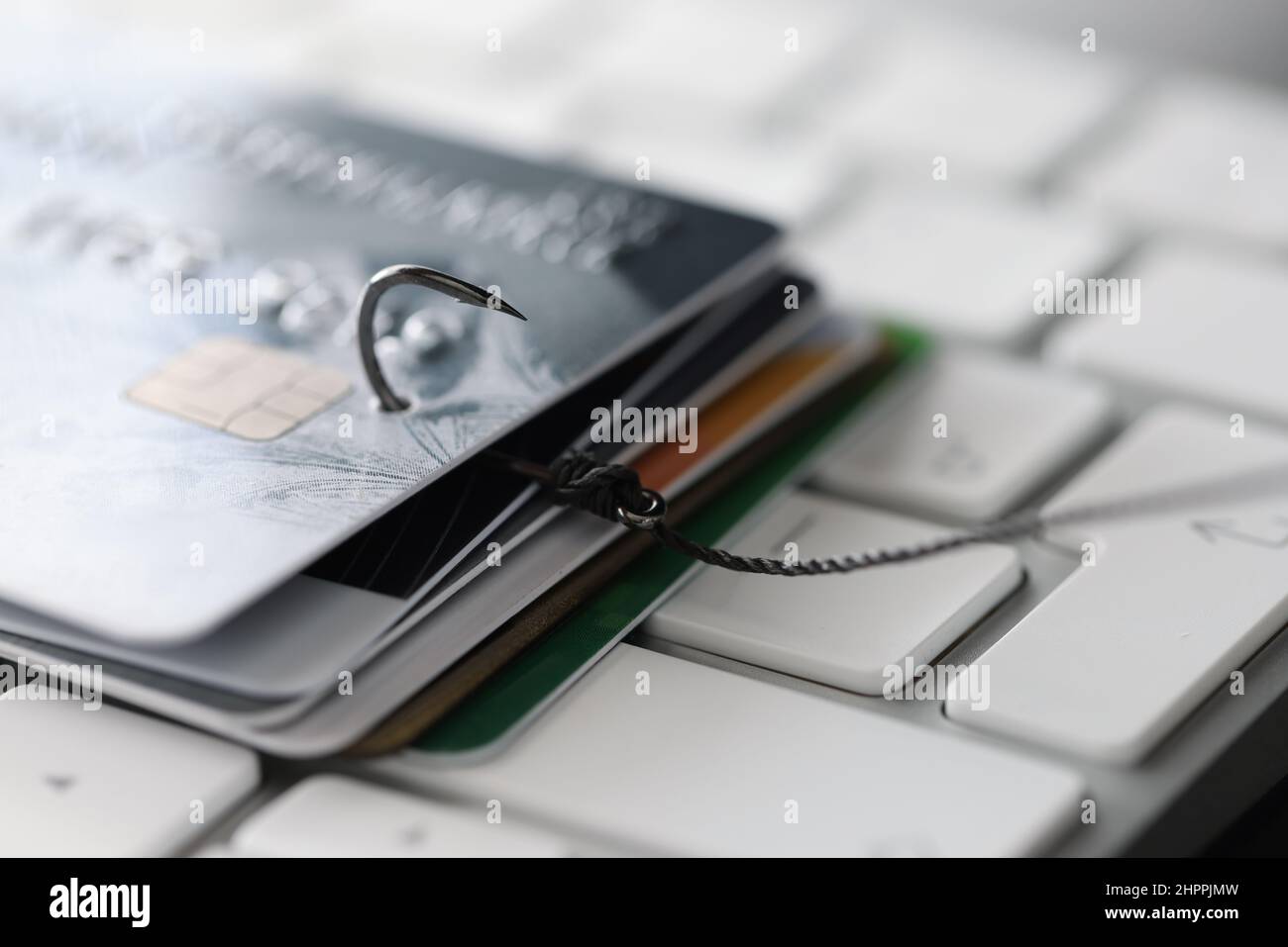 Gancio da pesca con carte di credito sul primo piano della tastiera Foto Stock