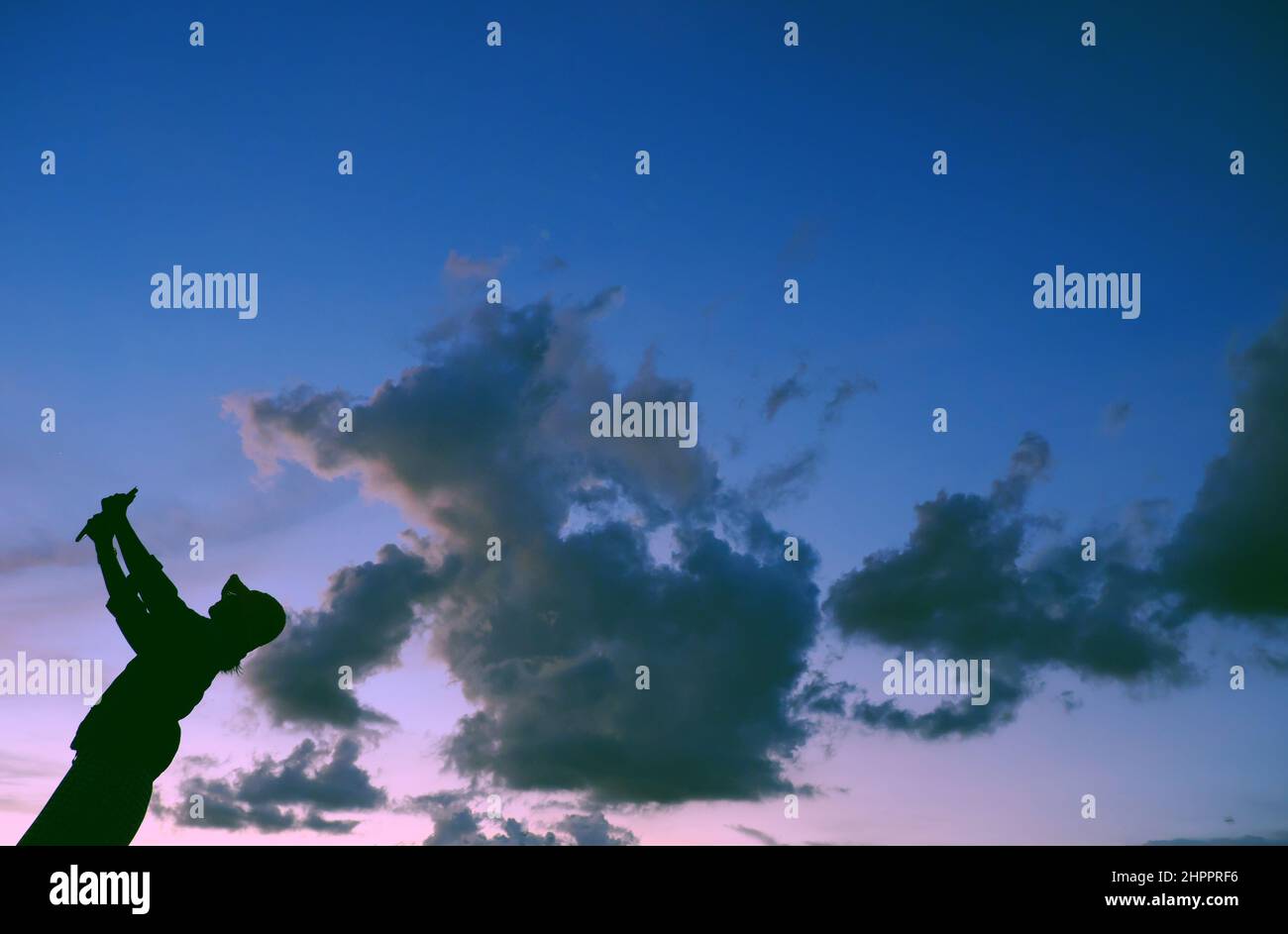 Scena divertente al tramonto quando silhouette di donna vietnamita correre quando forma animale da nube inseguimento, donna impostare sul tetto quando rimanere a casa in sociale Foto Stock